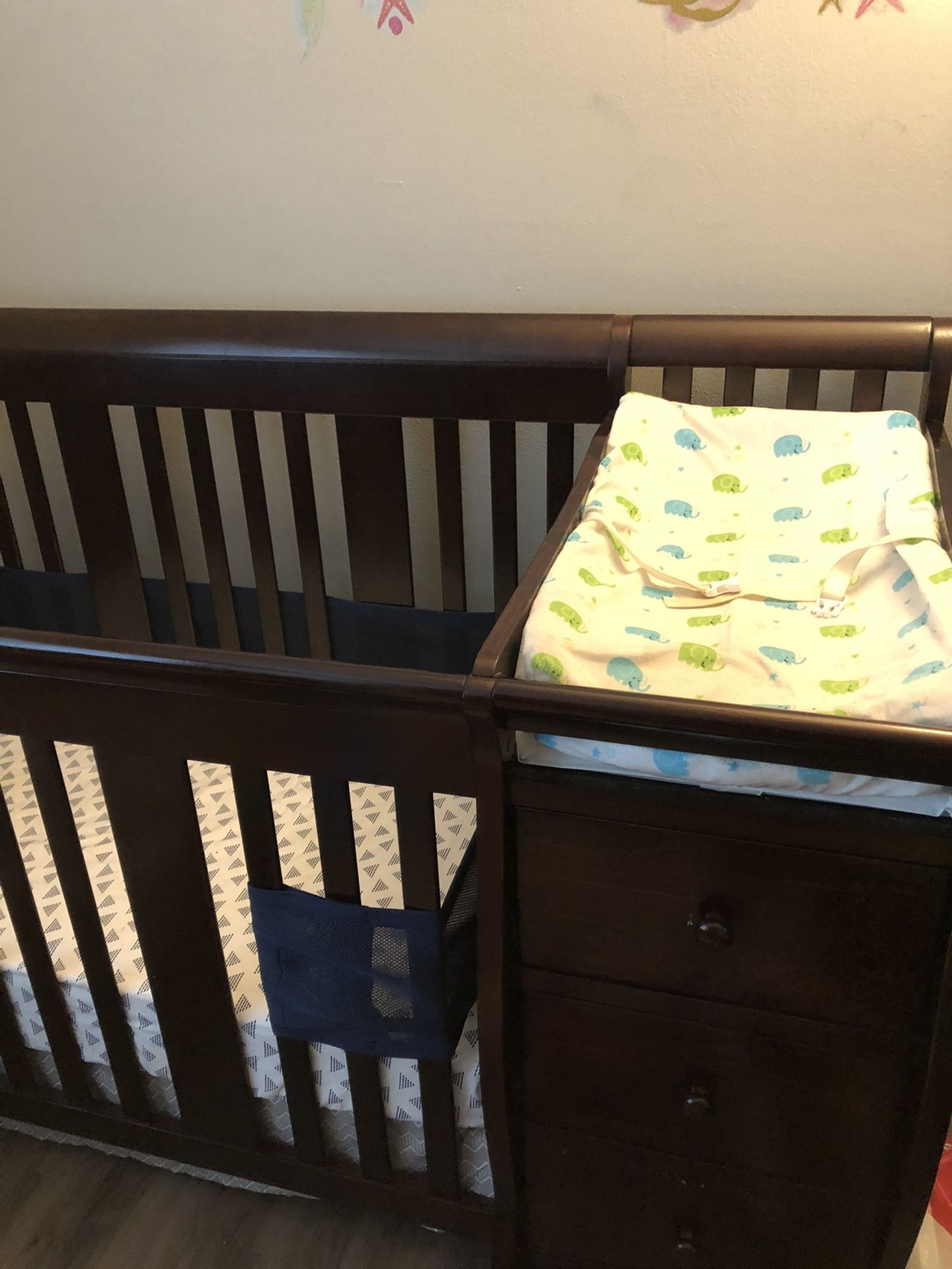 Convertible crib with changing table attached.