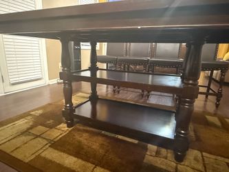 Dark wood kitchen table set with four chairs