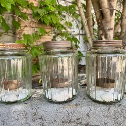 Three outdoor candle holders. 