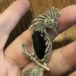 Sparkling sterling marcasite onyx parrot with a ruby eye brooch pin