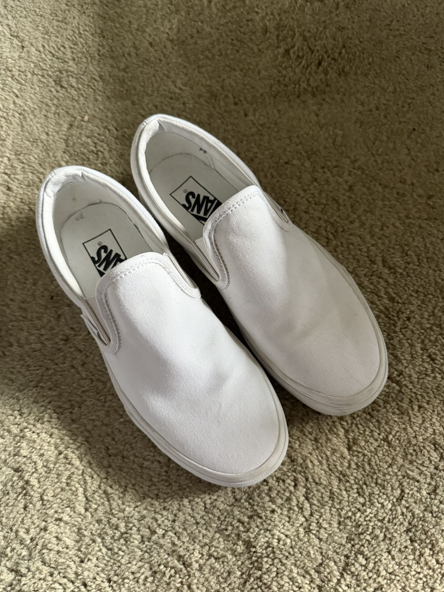 All white slip on vans