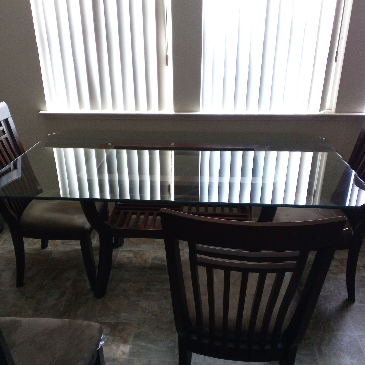 Glass table with five chairs