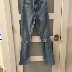 Zara medium-wash straight-leg jeans, featuring ripped knees and a frayed hem. Size 4