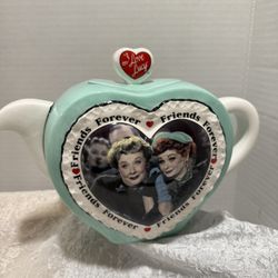 The "I Love Lucy Friends Forever Teapot" is a vintage ceramic tea pot 