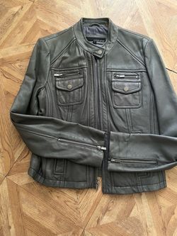 Dark gray Leather Jacket by wilsons with a stabd collar and zippered front pockets size M for women