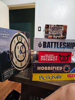 5  board games and one wooden ring toss