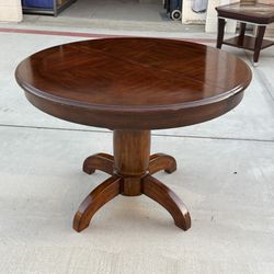 Expandable Round Pedestal Dining Table with Hidden Leaf