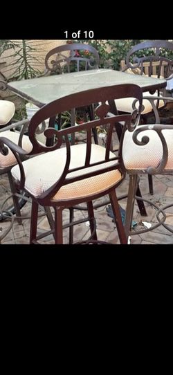 Heavy wrought iron patio barstools and table