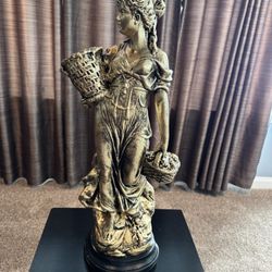 Lady holding the basket statue