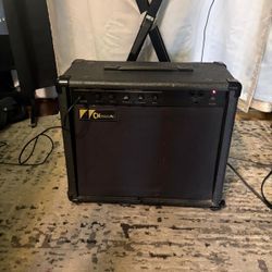 Charvel CH-200B bass amplifier. It is a solid-state combo amp with a 20-watt output and a single 8-inch speaker.  It was manufactured in the early to 