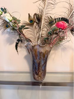Decorative vase with real peacock feathers