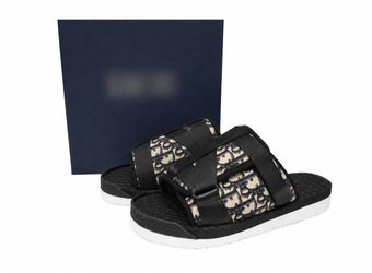 Black D..I..O..R slides with textured woven pattern
