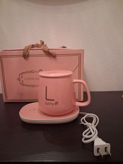 Coffee cup and saucer in pink, red, and green