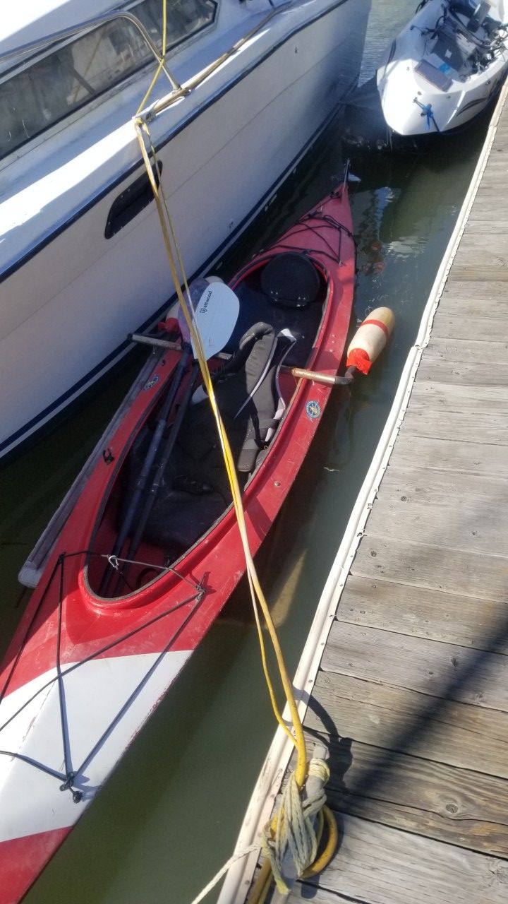 Kayak with foot controlled rudder and stabilizing pontoons. One set of double bladed paddles comes with it as well as 2 life jackets.