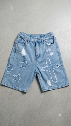 Blue and white jean shorts with cross/star patchs