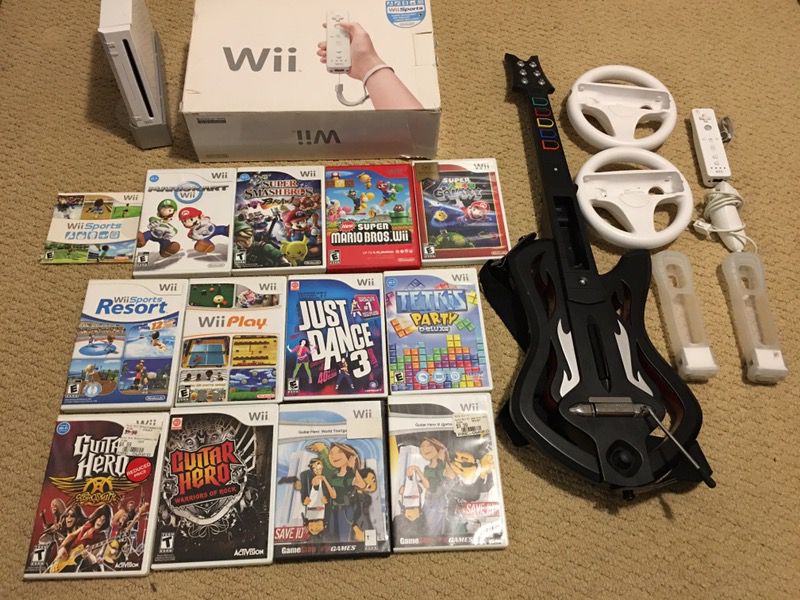 Nintendo Wii with games, guitar and one controller