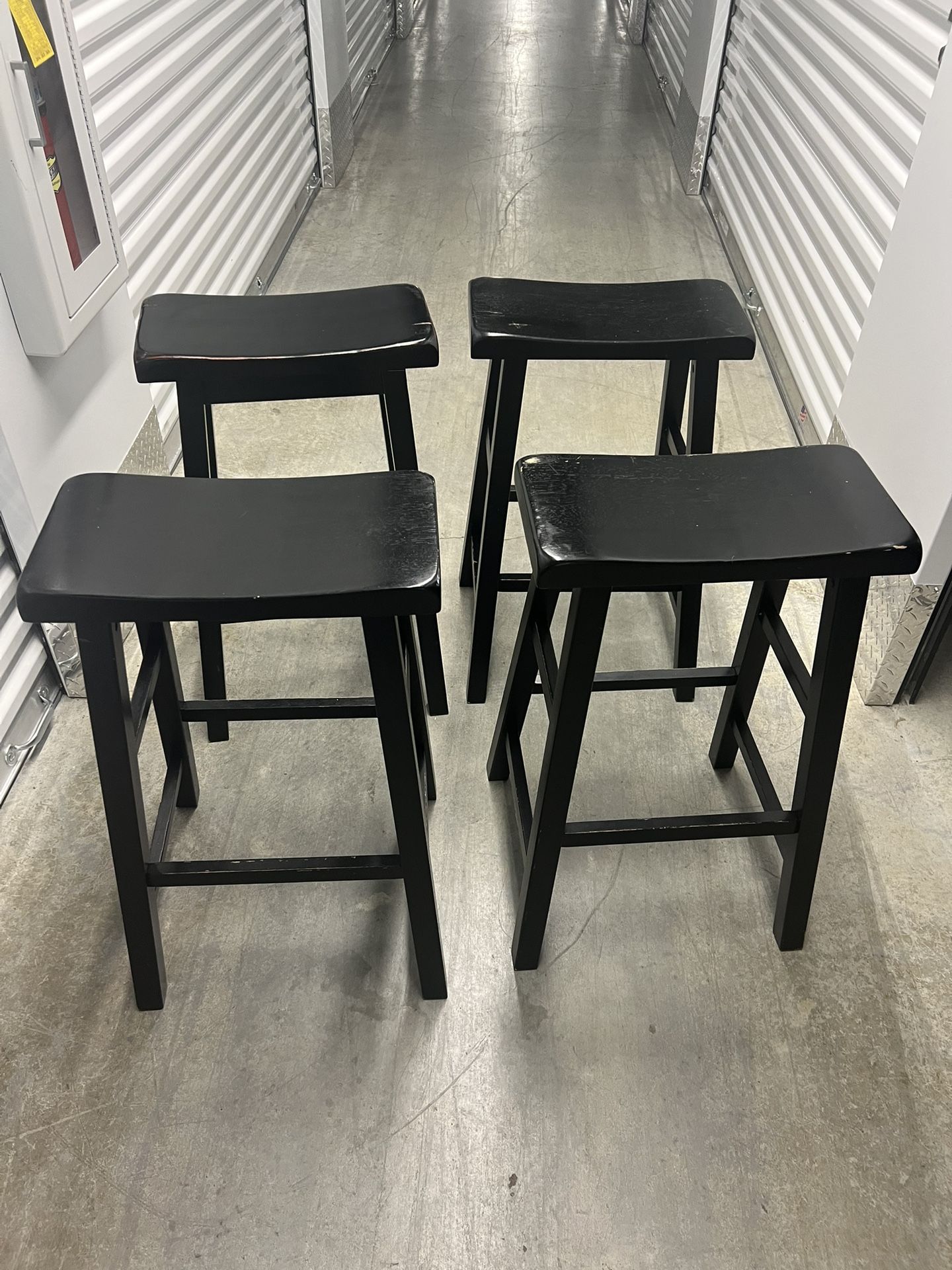 Four wood black stools