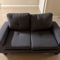 Small blue/grey two seater couch