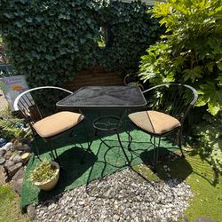 Metal bistro table with two matching chairs