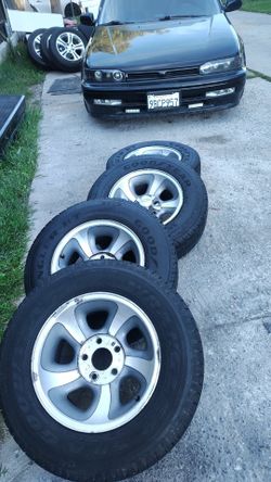 Wheels and tires 15 for Chevy s10or Sonoma rims good shape tires not that good
