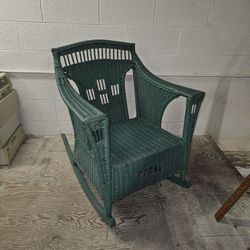 Antique green wicker rocking chair. 
