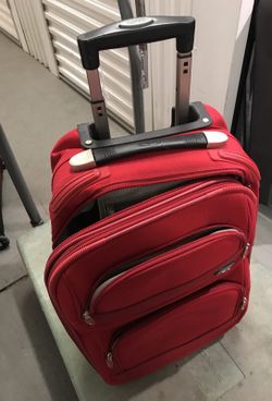Small carry-on Red Olympia luggage (used, but all zippers, handles and wheels working)