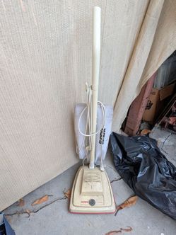 This vintage Eureka upright vacuum cleaner appears to be a Model 1432 or a similar 1980s Convertible model.