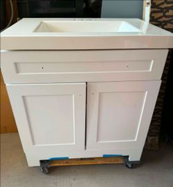 30" BATHROOM VANITY NEW IN WHITE COLOR, DAMAGE ON THE LEFT SIDE