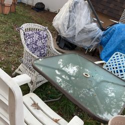 A Set Of Patio Furniture, With A Glass Table, 4 Different Chairs, They Need A Little Cleaning From Being Outside All For $75