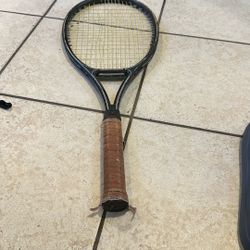 Black Tennis Racket With Brown Leather Handle