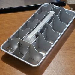 vintage aluminum ice cube tray with a lever release mechanism