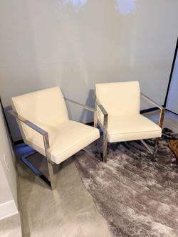 Pair of white faux leather accent chairs