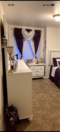 White dresses and mirror with night stand