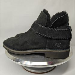 Size 7.5 US UGG McKay ankle boots in black suede, featuring a signature whipstitched strap and sheepskin