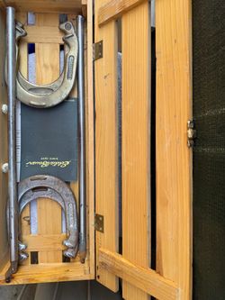 Eddie Bauer Horseshoe Set featuring forged steel shoes and stakes housed in a branded wooden carrying crate.