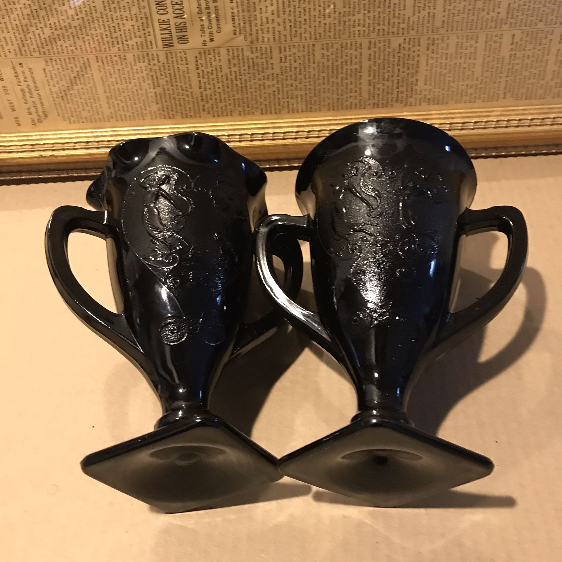 Pair of LE SMITH BLACK AMETHYST trophy shape vases. One with ruffle rimmed and one without. Made in the early 1930 in USA. In light they turned into