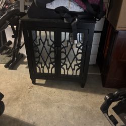 Elegant Mirrored Cabinet with Decorative Doors