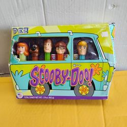 Scooby Doo PEZ Gift Set featuring Fred, Velma, Shaggy, Scooby, and Daphne dispensers, packaged in a box shaped like the Mystery Machine. collectible