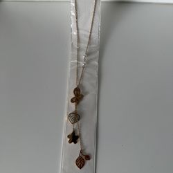 Necklace and earrings of heart and charms of leaves, star, butterfly and heart