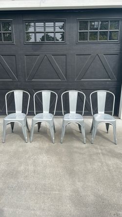 Set of 4 industrial metal dining chairs in silver/gunmetal finish.