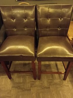 Four brown leather antique chairs
