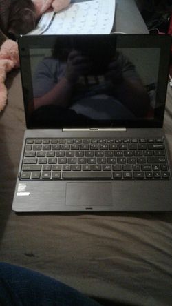 Black and Grey Asus laptop computer with detachable Bluetooth keyboard 200 obo