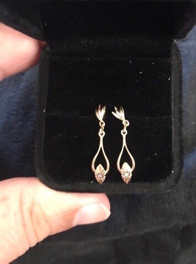 New. 14k yellow gold dangling earrings. Each has a small diamond. Solid gold. Great gift for the woman in your life for Summer or birthday. Eac