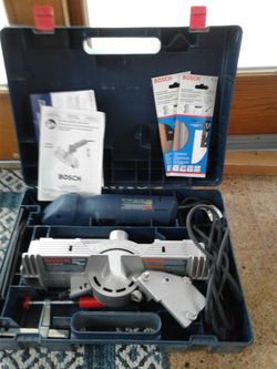 Bosh power handsaw with table attachment kit.