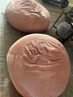Two pink bean bags trying to sell together