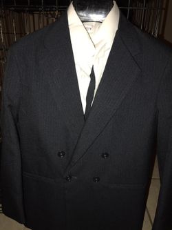 Navy pin stripe double breasted suit. Size 12 regular. Worn once.