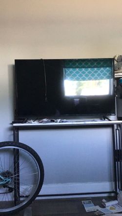 Vizio TV with remote control and a Roku stick, TV stand included.