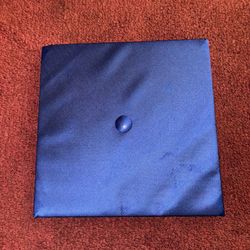 Blue Graduation Cap 	•	Description: Classic blue graduation cap with an elastic band for fit. 	•	Brand: Herff Jones