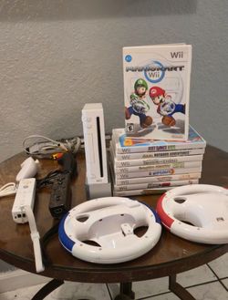 Nintendo Wii Console, Mario Kart Family Bundle with 9 Games, 2 Controllers, and Racing Wheels. Loaded