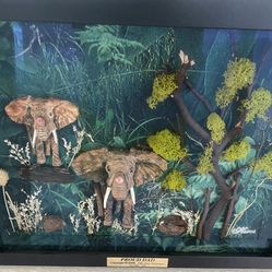 Very unique 1 of a kind 3-D effect beautiful hand sculpted and hand painted mother and baby elephant enclosed in a very expensive shadow box.   Set in